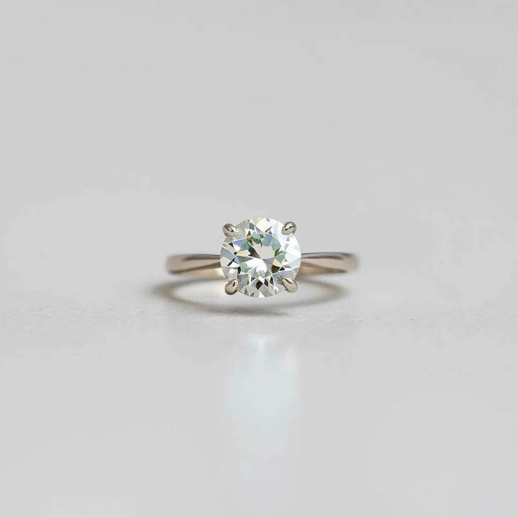 Moissanite engagement ring with a round brilliant center stone in an elegant setting under soft natural light