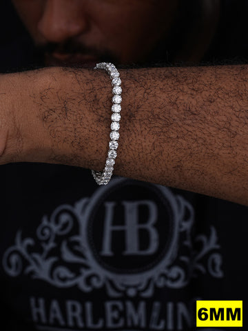 Diamond bracelet on a wrist with 'Harlemline' branding in the background