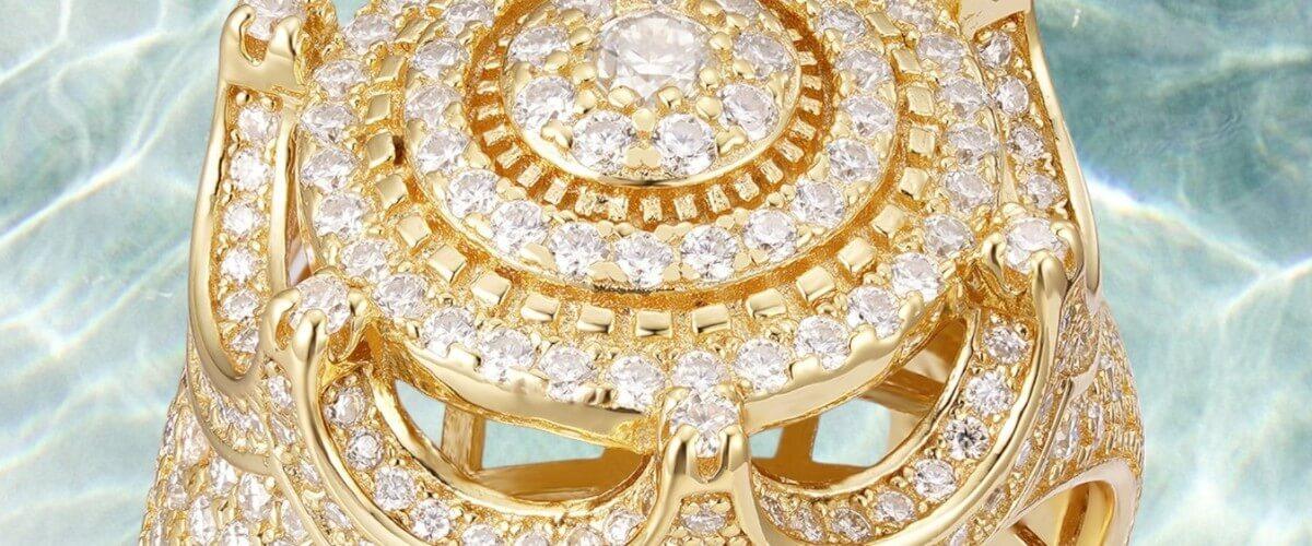 Gold ring with diamonds on a light blue marble background